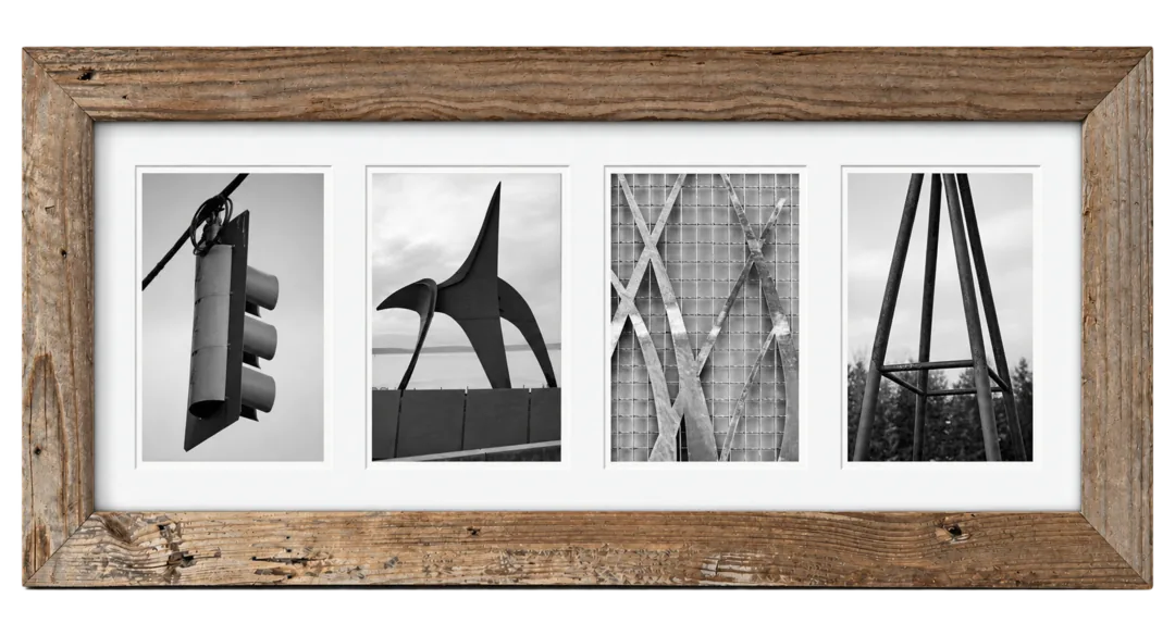 EMMA spelled from found letters — a traffic signal, a sculpture, a wire fence, an A-frame tower — in a weathered barnwood frame.