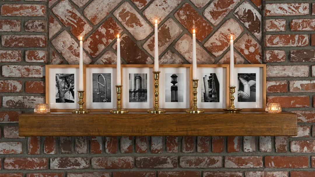FAMILY spelled from found letters, displayed on a mantel by candlelight, in light wood frames.